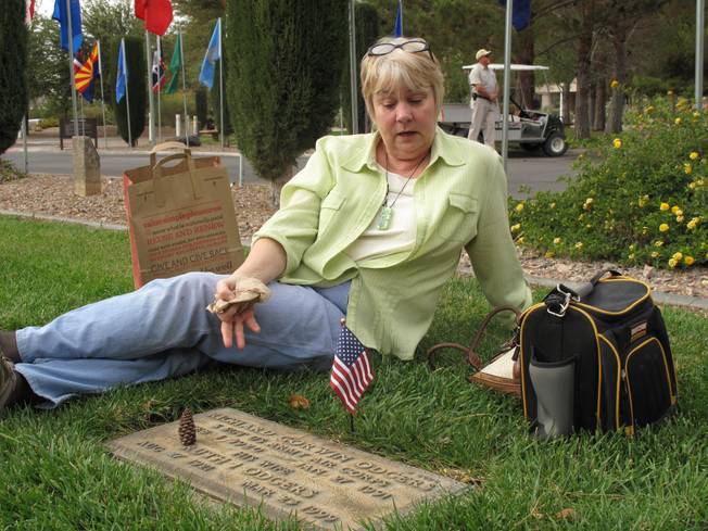 Janie Odgers visits her husband's parent's grave at the Southern Nevada Veterans Memorial Cemetery in Boulder City on Veterans Day.