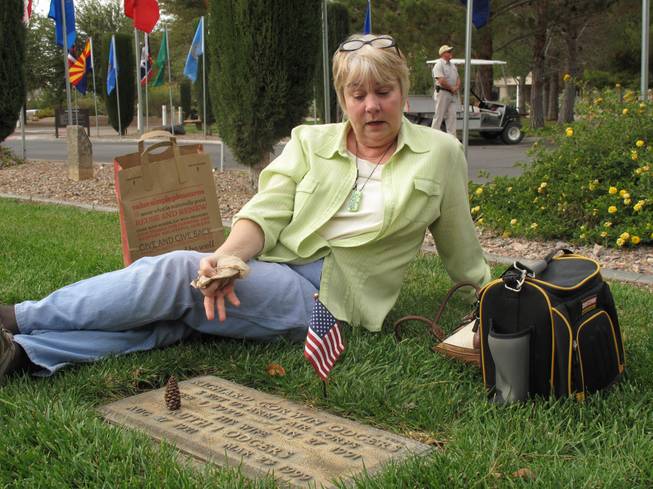 Janie Odgers visits her husband's parent's grave at the Southern Nevada Veterans Memorial Cemetery in Boulder City on Veterans Day.