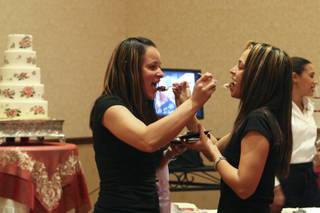 Ari Castellano and Imani Ortiz, right, who have already received their domestic partnership, plan for their commitment ceremony sampling wedding cake while attending the LGBT Wedding Expo hosted by the Rainbow Wedding Network Sunday at the JW Marriott Las Vegas Resort & Spa.