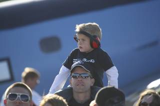 A father and son watch the U.S. Air Force Air Demonstration Squadron Thunderbirds perform during the 2009 Aviation Nation air show Saturday at Nellis Air Force Base.