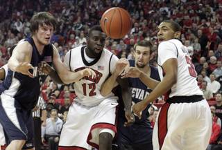 UNR forwards Luke Babbitt, left, and Adam Carp battle with UNLV forward Brice Massamba and guard Anthony Marshall as they chase down a loose ball during the first half of their game Nov. 18, 2009, at the Thomas & Mack Center. UNLV won 88-75.