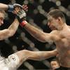 Jacob Volkmann, left, battles it out with Paulo Thiago during UFC 106 Saturday, November 21, 2009 at the Mandalay Bay Events Center.