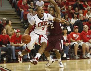 UNLV's Anthony Marshall drives past Kendal Brown-Surles during the first half against Southern Illinois at the Thomas & Mack Center Saturday.