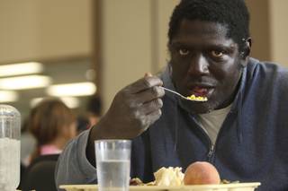 Melvin Miller, 51, enjoys a Thanksgiving meal during the annual holiday community dinner Wednesday night at the Las Vegas Rescue Mission.