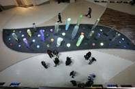 Invited guests and media walk past a water sculpture titled Halo before the official opening of Crystals, the retail and entertainment district of CityCenter.