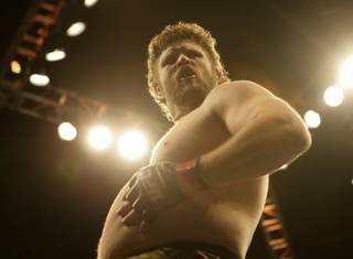 Roy Nelson lifts celebrates after winning Brendan Schaub in the main event of the Ultimate Fighter Championship Saturday night at the Palms.   Nelson won the fight and the six-figure contract with the UFC.