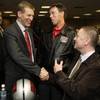 New UNLV head football coach Bobby Hauck, left, meets boosters Rich Abajian, center, and Tyler Corder during a news conference at UNLV Wednesday, December 23, 2009. Hauck had a 80-17 record at Montana where he was the head coach from 2003.
