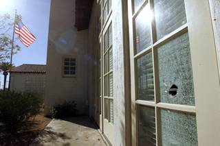 A bullet hole is seen in the window of the 5th Street School Tuesday, January 5, 2010 as a result of the previous day's shoot out that killed a court security officer and the gunman and injured a deputy U.S. marshall.