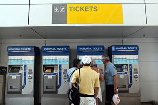 Tourists look at ticket prices and routes of the Las Vegas Monorail at the Flamingo station on Monday, June 22, 2009.