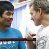 Manny Pacquiao speaks with his trainer, Freddie Roach, during a workout at Wildcard Boxing Gym in Hollywood, Calif. on Feb. 1, 2010.