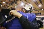 Bishop Gorman football player Evan Palelei, right, who is headed to Navy, hugs the Bishop Gorman football team's linebacker coach Gino DiMaria during National Signing Day at Bishop Gorman High School in Las Vegas Wednesday, February 3, 2010.