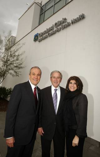 Former President George W. Bush is given a tour of the Cleveland Clinic Lou Ruvo Center for Brain Health by Larry Ruvo on Feb. 10, 2010. With them is Camille Ruvo, Larry's wife.
