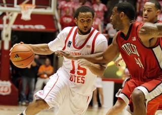 Utah guard Carlon Brown (15) drives around UNLV forward Darris Santee (44) during the Utes' 66-61 upset victory over the Rebels in Salt Lake City on Feb. 17.