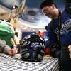 Alec Venegas, 4, (right) of Midland, Texas, with his father Eric, looks on in disbelief at Kyle Busch at an autograph-signing event at M&M's World in Las Vegas on Thursday, Feb. 25, 2010.
