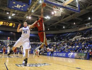 Air Force's Mike McLain (33) hammers UNLV's Anthony Marshall (3) during the first half of Saturday's game at Clune Arena.  McLain was called for an intentional foul on the play, while Marshall finished the day with eight points in a 77-47 Rebels win.