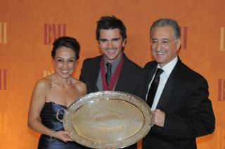 Grammy and Latin Grammy Award winner Juanes, center, receives the BMI President's Award from BMI Assistant Vice President, Latin Music, Los Angeles Delia Orjuela and BMI President and CEO Del Bryant at the 16th Annual BMI Latin Awards at the Bellagio on March 4, 2010.