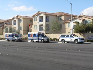 Emergency vehicles park outside the Silver Pines apartment complex, 6650 E. Russell Road,  where a fatal police-involved shooting occurred Monday afternoon. One woman was killed, and three others - including the suspect - were injured and taken to the hospital, police said.
