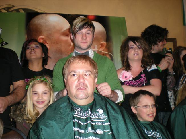 <em>American Idol</em> Season 6 runner-up Blake Lewis shaves the head of CBS Radio's Cat Thomas on March 6, 2010.