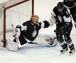 Wranglers defenseman Chris Frank blocks a shot in front of outstretched goaltender Joel Gistedt during the first period of play on Thursday night.