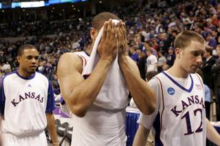 Kansas players leave the floor after Saturday's second-round NCAA Tournament game against UNI at the Ford Center in Oklahoma City. UNI upset No. 1 seed Kansas 69-67 to advance to the Sweet 16.