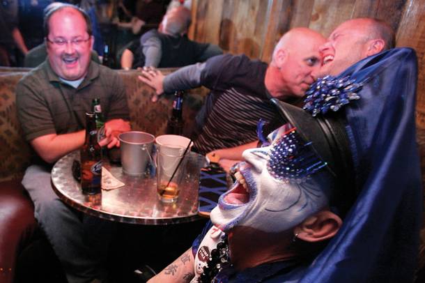 Tracy Skinner, dressed as Mother Loosy Lust Bea Lady of the Sin City Sisters of Perpetual Indulgence flirts with a bar patron as she gives out raffle tickets during a beer bust hosted by the Sin City Sisters to raise money at the Funhog Ranch in Las Vegas Saturday, March 20, 2010.