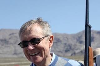 Sen. Harry Reid unloads his personal 12-gauge shotgun during the grand opening of the Clark County Shooting Park in Las Vegas Saturday, March 27, 2010.