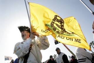 Dressed in period costume, William Temple from Brunswick, Ga., calls for revolution at the 