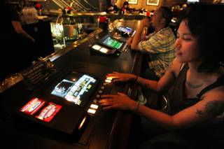 Nicole Sheldon plays a Gamblers Bonus game Friday at Chicago Brewing Co. Gamblers seem to be favoring video poker bars over locals casinos in the recession.