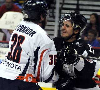 Wranglers forward Alex Bourret spars with former Vegas player Sean O'Connor near the Ontario net during the third period on Friday night.
