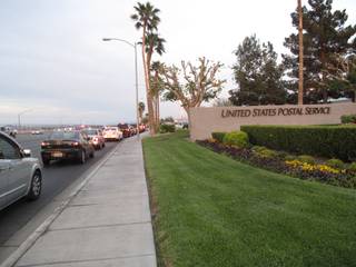Drivers line up Thursday at the Sunset Road post office to mail their tax returns.
