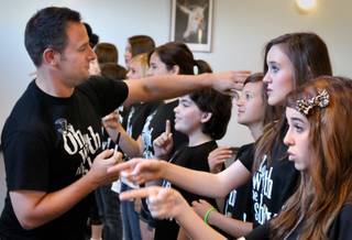 Artistic Director Greg Kata brushes Rylee Zavala's hair out of her eyes during an On With The Show! rehearsal at the Shine Dance and Performing Arts Academy. He later warned he was bringing scissors to a performance to cut anyone's hair that was hanging in their eyes. 