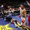 Referee Kenny Bayless checks on Ricky Hatton after Manny Pacquiao knocked out Hatton in the second round of their junior welterweight fight at the MGM Grand Garden Arena in Las Vegas, Nevada May 2, 2009. Pacquiao's Filipino trainer Buboy Fernandez is at right.