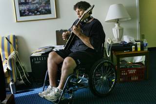 Tom Urbanski practices the guitar in August 2008. Paralysis after being shot in 2007 hasn't kept the former professional wrestler and bouncer out of the spotlight.