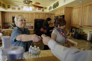 Former Assemblywoman Kathy McClain, Democratic candidate for Senate District Seven, hands out supplies to volunteers in her kitchen before canvassing neighborhoods Monday May 24, 2010. McClain faces another former assembly veteran Mark Manendo in the June 8 primary.