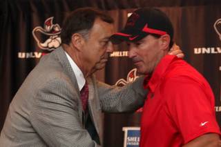 UNLV athletic director Jim Livengood and UNLV's new baseball coach Tim Chambers shake hands after a press conference at UNLV's Si Redd Room Friday, June 11, 2010.