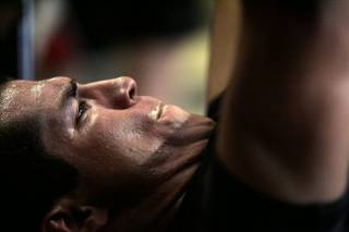 Pahrump high school athlete Jon Mitchell grimaces while doing bench presses during a work out with trainers from the Philippi Sports Institute Tuesday, June 22, 2010 in Pahrump.
