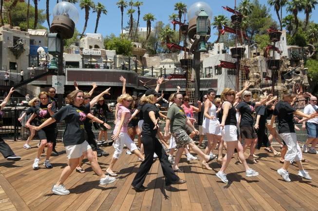 Former cast members dance in front of Treasure Island during the 70th anniversary reunion of the Ice Capades on June 22, 2010.