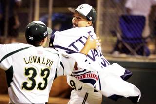 Spencer Cofer celebrates by wearing their district championship banner and running around after Paseo Verde beat Henderson during the District 2 championship of the Little League Majors Division at Arroyo Grande Sports Complex in Henderson Thursday, July 8, 2010.