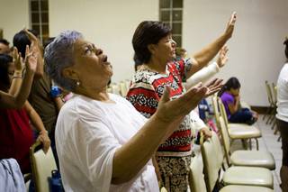 Rosa D. Rios looks upward during an immigration vigil at Amistad Cristiana, an interdenominational church on Stewart Avenue, Thursday, August 5, 2010. Pastor Joel Menchaca said he called the vigil because many people were fearful after a series of immigration raids last week. 