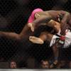 Photo: Phil Davis, top, tackles Rodney Wallace during UFC