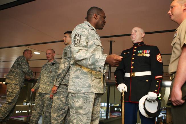 Nellis Air Force Base Installation Command Chief Sgt. Al Herring, center, visits with retired Marine Sgt. Jason Brooks and Sgt. Tyler Corbaley, right, before the groundbreaking ceremony of the new USO lounge in Terminal 1 at McCarran International Airport on Wednesday, August 18, 2010.