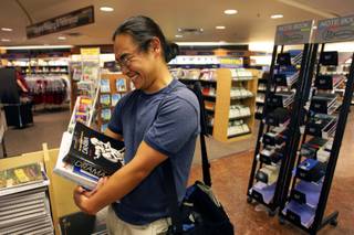 Matt Kimball, a junior majoring in journalism, theater and political science, picks up some books at the bookstore during the first day of the fall semester at UNLV Monday, August 23, 2010.