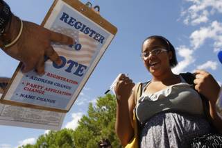 UNLV freshman Ollie Hernandez, 18, finishes registering to vote at an Organizing for America booth on UNLV campus Tuesday, August 24, 2010. Due to the economy, many of the young voters that swept President Obama and Rep. Dina Titus to victory in 2008 have left the area. Mid-term elections are also historically uninteresting to young voters. Organizing for America and the Democratic Party are trying to recruit first-time voters to fill in that gap.