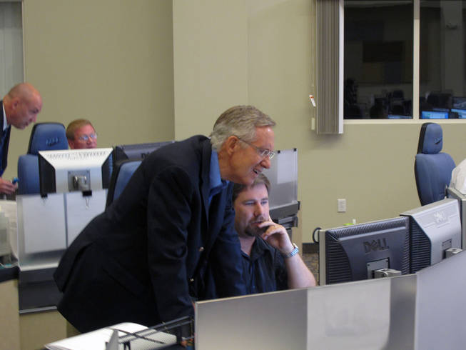 Sen. Harry Reid looks at Traffic Technician John Doran's computer screen in the Freeway and Arterial System of Transportation traffic management center on Friday, Oct. 22, after Reid participated in a press conference announcing the approval of a Record of Decision for Project Neon, which will improve Interstate 15 in Las Vegas.