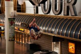 Las Vegas City Councilman Steve Ross zooms 800 feet down the Fremont Street Experience Zip Line on Thursday.
