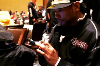Danny Davis Jr. uses his phone to text messages while waiting for auditions for the 13th season of The Ultimate Fighter Thursday, November 4, 2010.