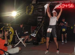 Andreas Wolpert celebrates after finishing first in the full-distance Nevada Silverman Triathlon in Henderson on Sunday. This was the German's first time competing in the triathlon.