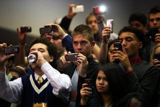 Students take pictures while surprise guests the Jabbawockeez perform during the Sun Youth Forum at the Las Vegas Convention Center Tuesday, November 23, 2010.