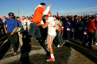 Bishop Gorman fans run onto Palo Verde's field Saturday, November 27, 2010. Gorman beat Palo Verde 28-10 to advance to the state championship game.