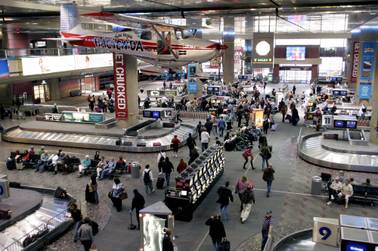 Travelers pick up their luggage at the McCarran International Airport baggage claim area in this file photo.